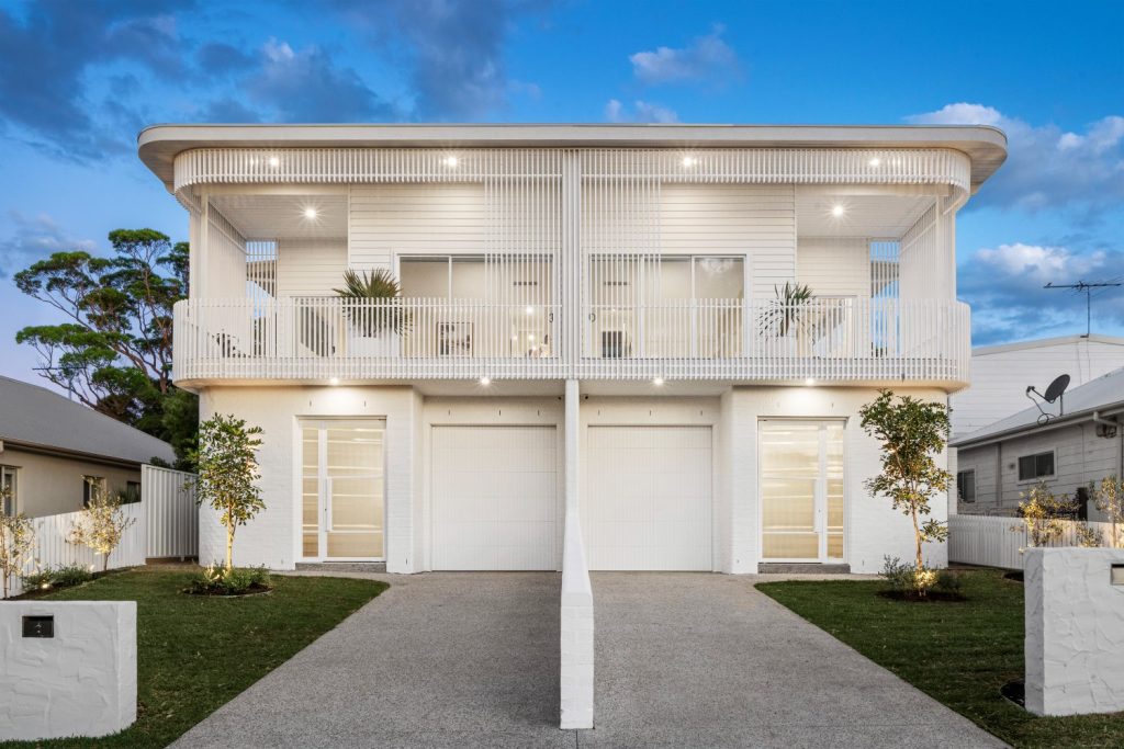 Modern duplex exterior lighting at twilight