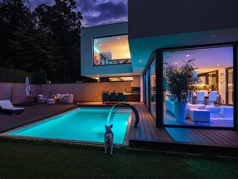 Premium home lighting by Randwick Electrical — pool and outdoor illumination at dusk